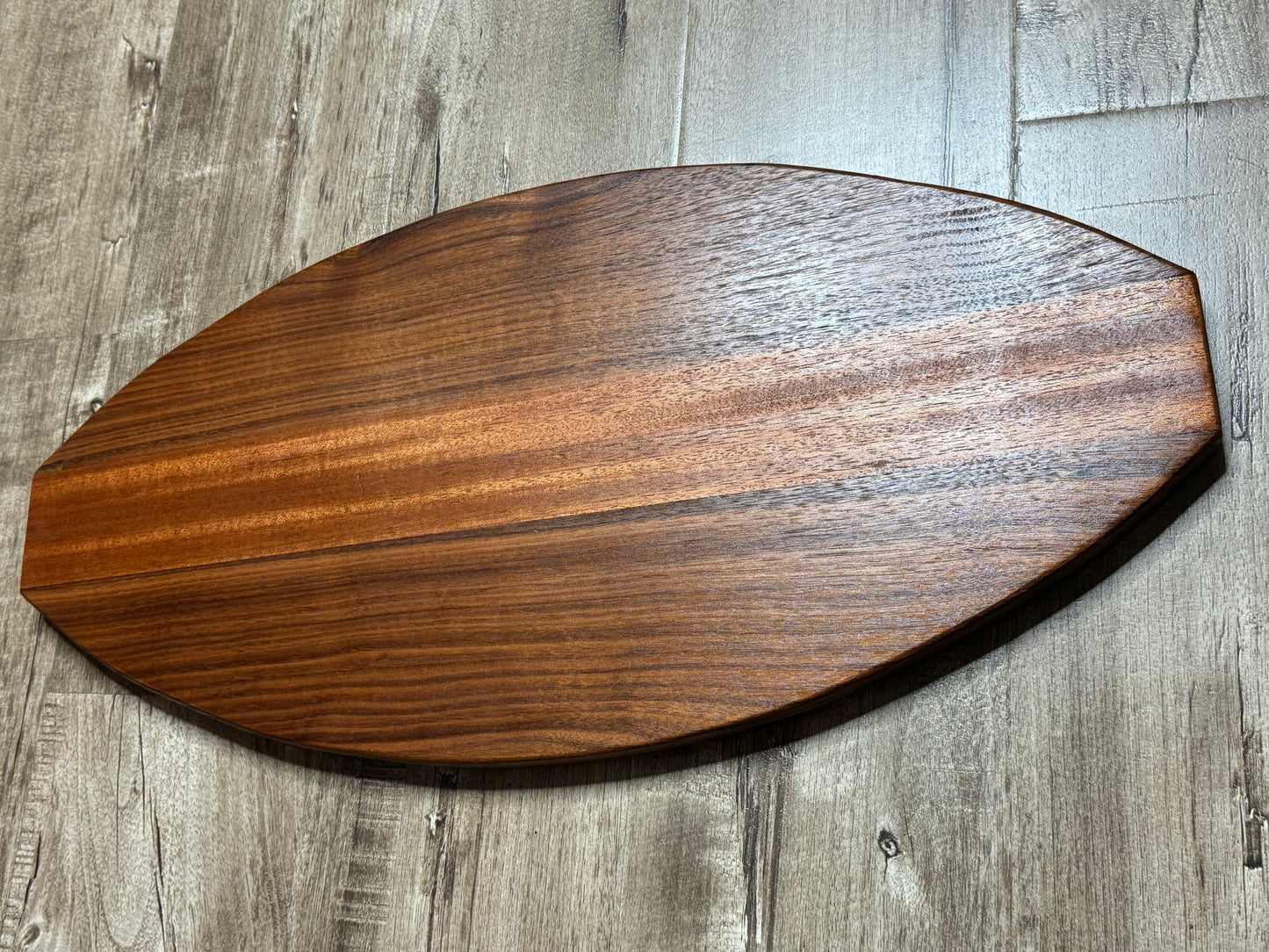 Walnut and mahogany football shaped cutting/charcuterie board